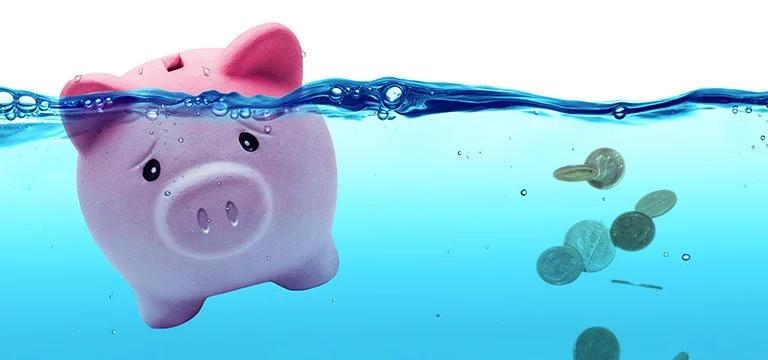 money and piggy bank in water