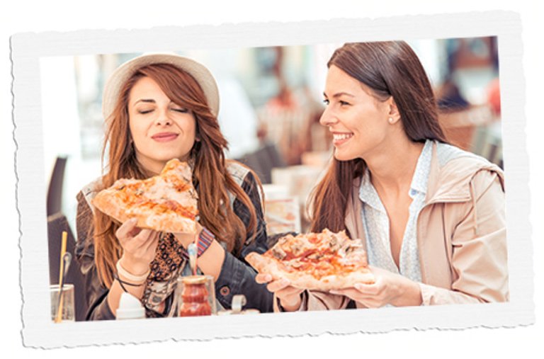 Two women enjoying pizza