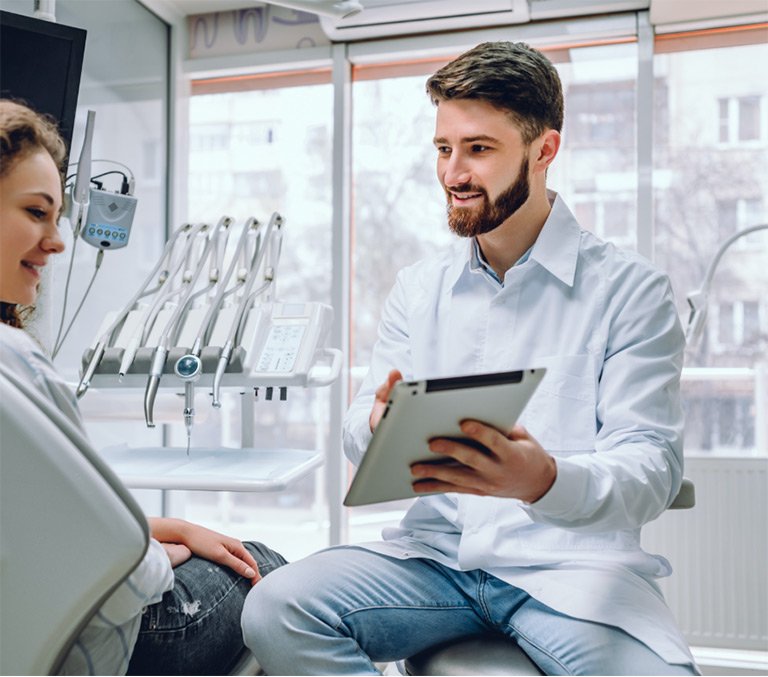 Man holding tablet in dental office